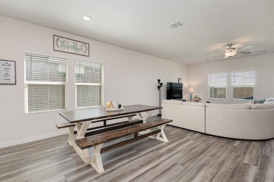 Dining room with light hardwood / wood-style flooring and ceiling fan