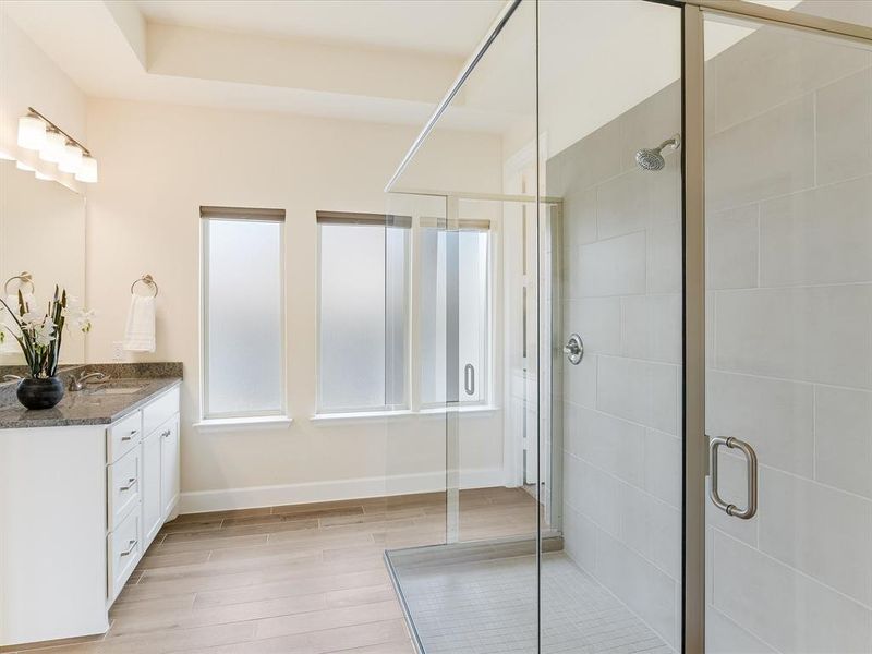 Luxurious primary bath with extra large walk-in shower, double vanity, TWO large walk-in closets and separate toilet closet.