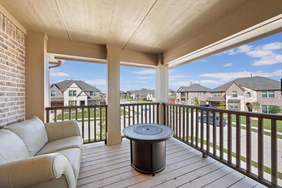 Wooden terrace covered balcony overlooks front yard and neighborhood and provides a nice outdoor living space off the gameroom.