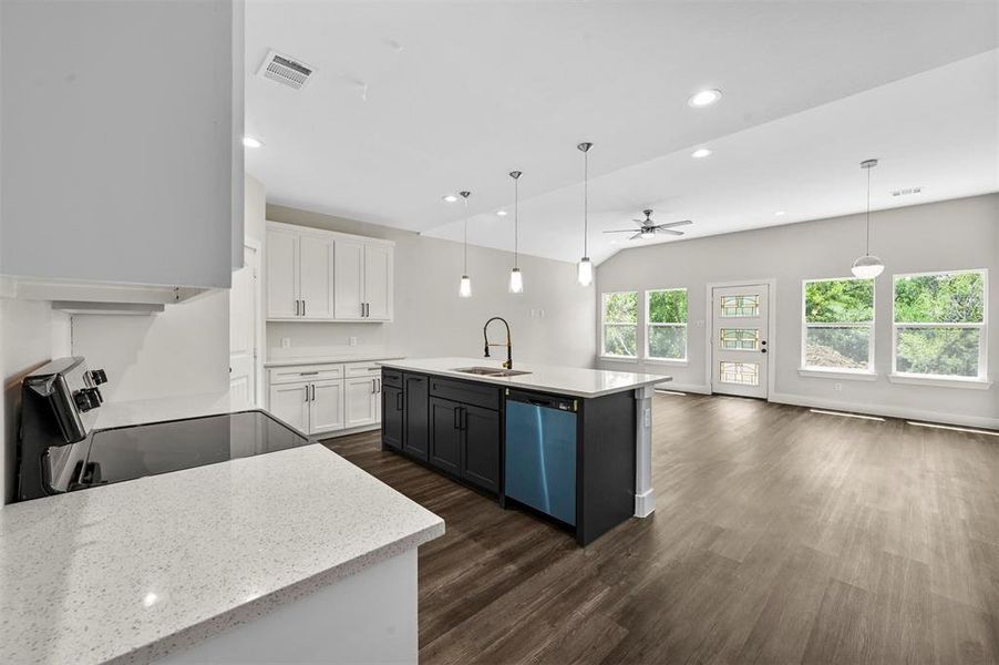 Kitchen featuring white cabinetry, sink, a kitchen island with sink, dishwasher, and dark wood-type flooring