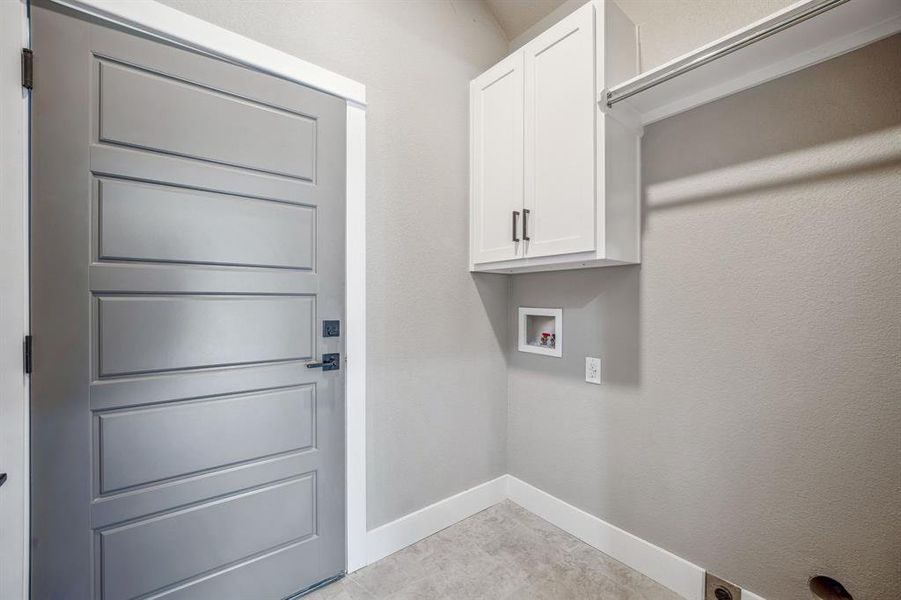 Laundry room featuring hookup for a washing machine and cabinets