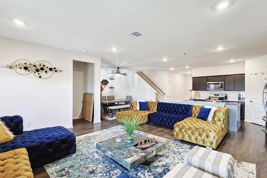 Living room featuring dark hardwood / wood-style flooring and ceiling fan