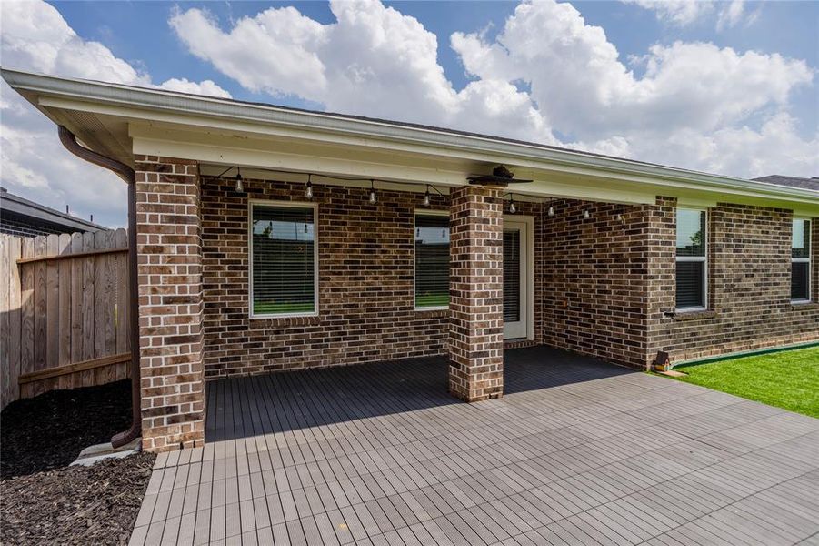 Oversized covered back patio w/extended tile patio is perfect for family gatherings.