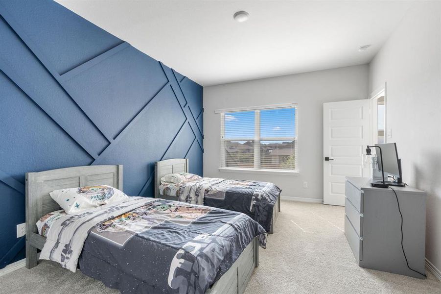 The fifth bedroom features plush carpet, large windows, and custom accent wall.