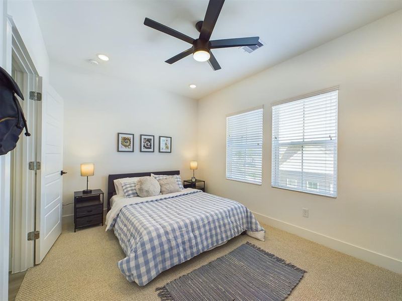 Secondary bedroom on the first floor. Photos from another community by the same builder, FINISHES & COLORS MAY VARY! Ceiling fans are not included!