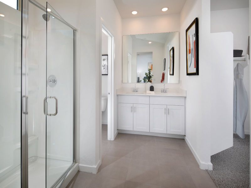 The ensuite bath features dual vanities and a large walk-in closet.