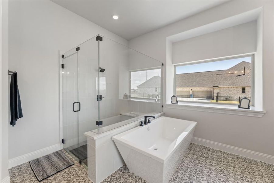 Bathroom with separate shower and tub and tile patterned floors