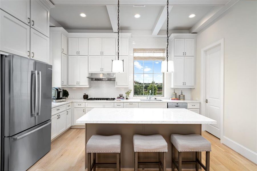 Bespoke kitchen with spacious island for many to gather and enjoy. Photo is of an existing home & used for representative purposes only.