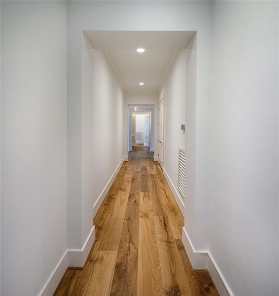 Second floor hallway leading to the secondary and primary bedrooms.  Lots of wall space for all your photos and artwork