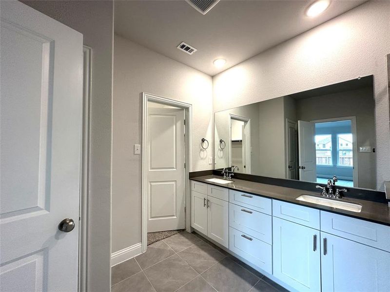 Bathroom with vanity and tile patterned flooring