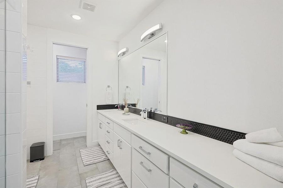 Bathroom featuring vanity and tile patterned flooring