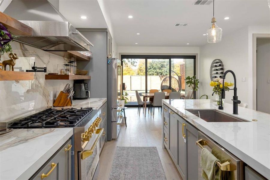 High-end stainless-steel appliances, including a gas rang, cater to culinary enthusiasts.