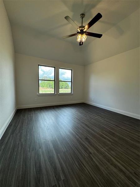 Spare room featuring ceiling fan and dark hardwood / wood-style flooring