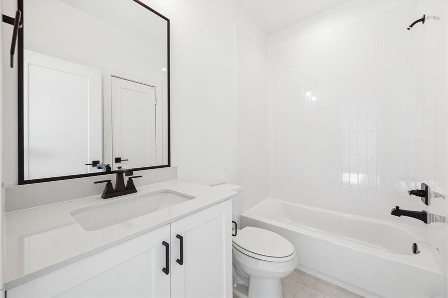 3rd full bathroom with shower/tub combination. Black accents create a modern aesthetic.