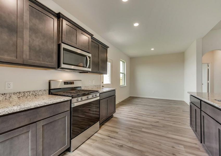 The kitchen is open to the dining room and has stunning vinyl plank flooring.