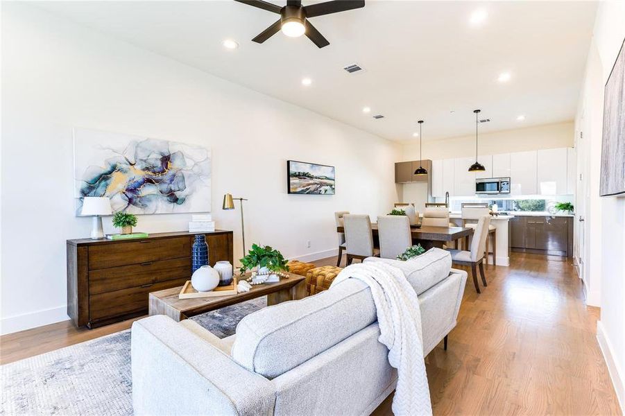 Living room featuring light hardwood / wood-style flooring and ceiling fan