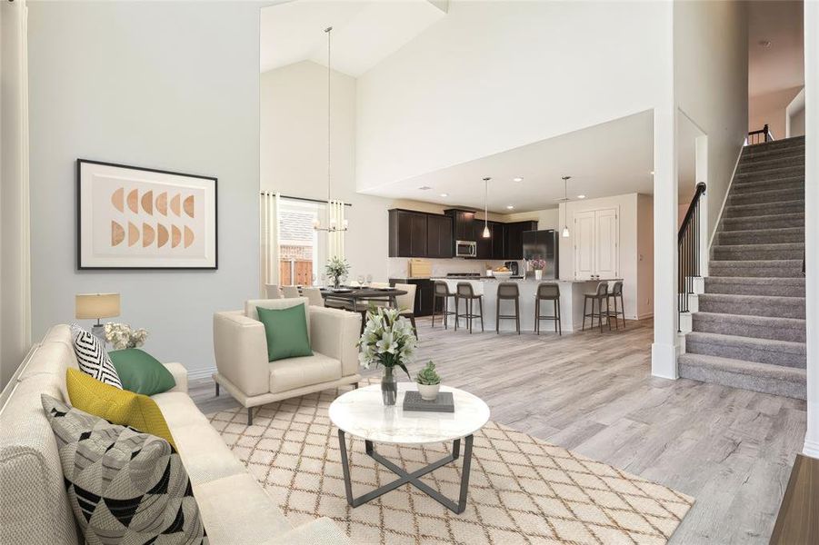 Living room featuring a notable chandelier, light hardwood / wood-style floors, and high vaulted ceiling