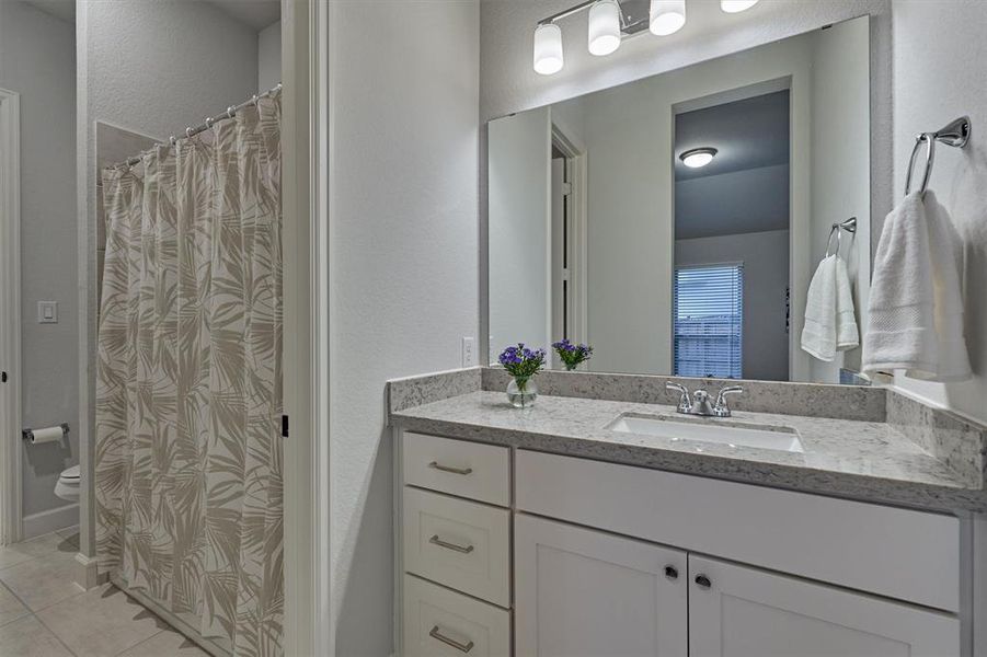 Convenience meets functionality in the utility room, complete with a sink and ample cabinet space, just steps away from the hall bath and guest suite. Note the smart mud room storage!