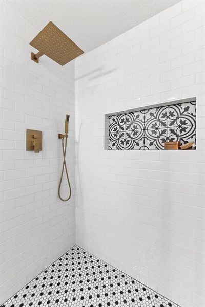 White and black penny floor tile and traditional white subway tile pay tribute to historic bungalow trends.