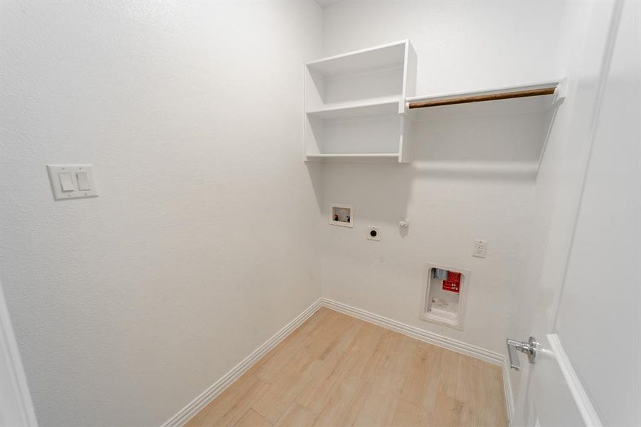 Laundry room with hookup for a washing machine, wood-type flooring, gas dryer hookup, and hookup for an electric dryer