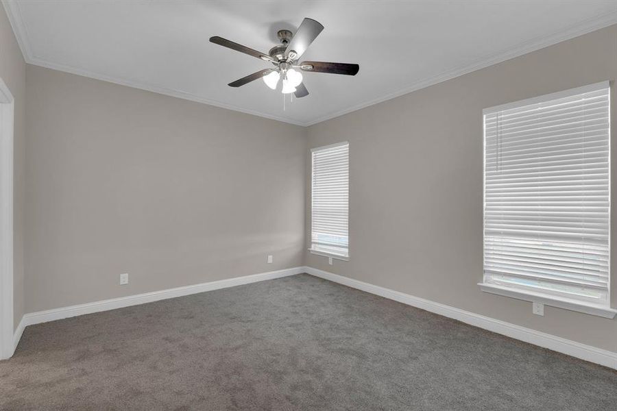 Bedroom featuring ornamental molding and ceiling fan