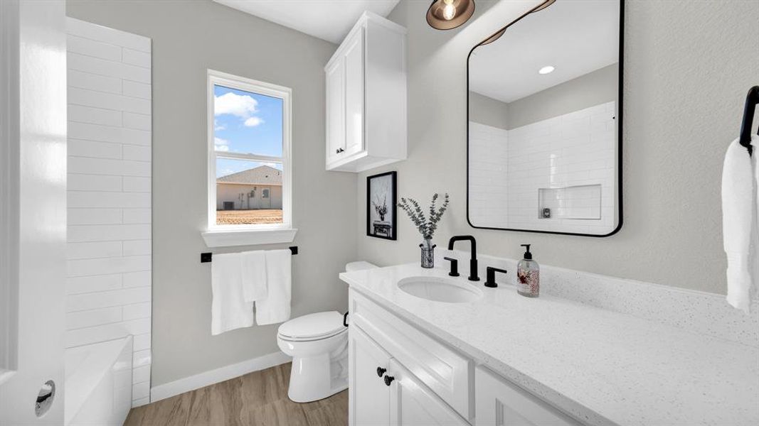 Tiled tub/shower combo in the 2nd hall bath.