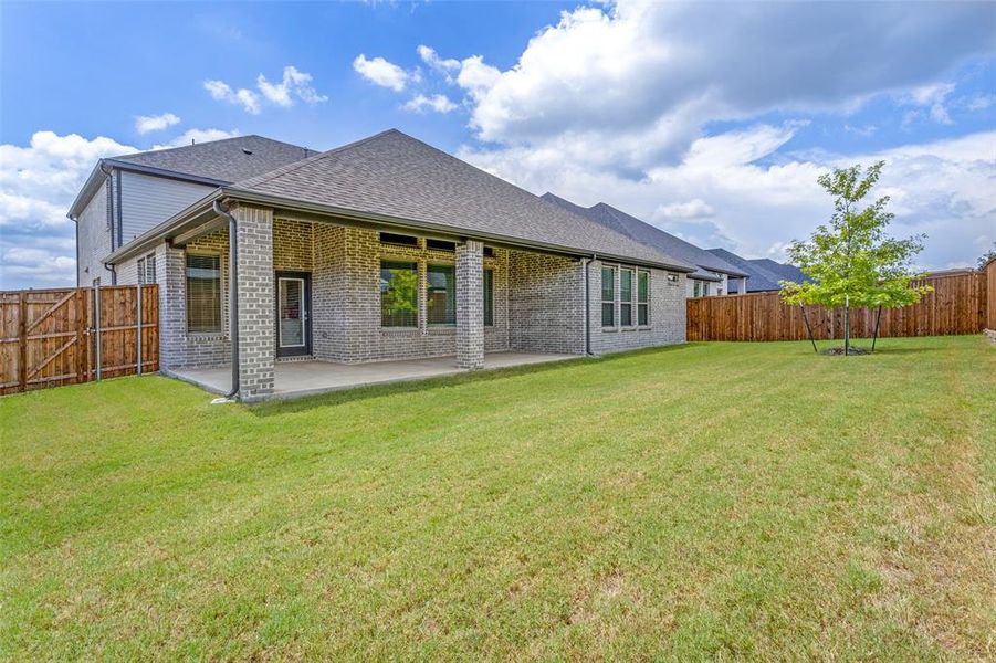 Back of property featuring a patio area and a yard