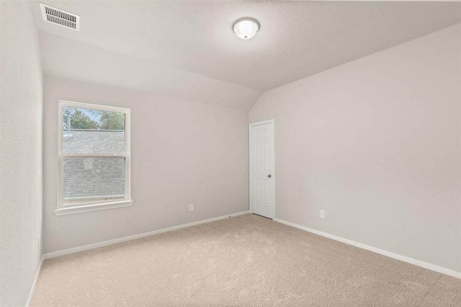 Your secondary bedroom features plush carpet, fresh paint, closet, and a large window that lets in plenty of natural lighting.