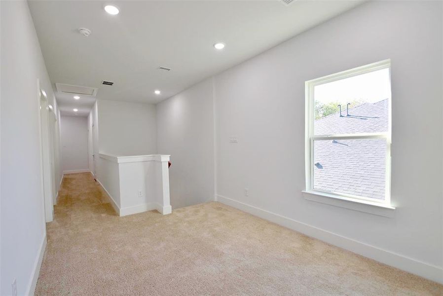 Spare room with light colored carpet