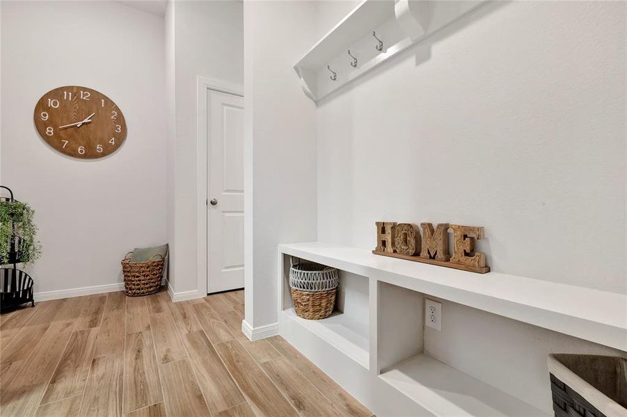 Custom Mudroom - Custom upgrade with storage, bench, and extra space. Beautiful flooring and functional design enhance daily living.