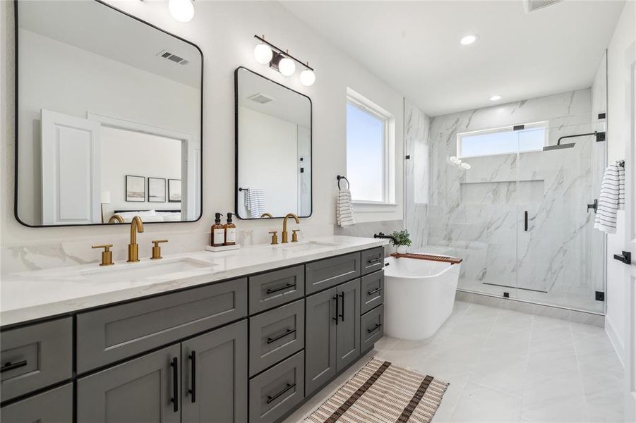 Indulge in luxury with this primary ensuite, featuring his-and-hers sinks, a standalone soaking tub, and a frameless walk-in shower that exudes sophistication and style.