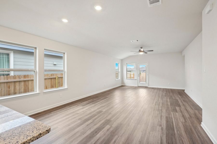 Dining room and living room in the Allen floorplan at a Meritage Homes community.