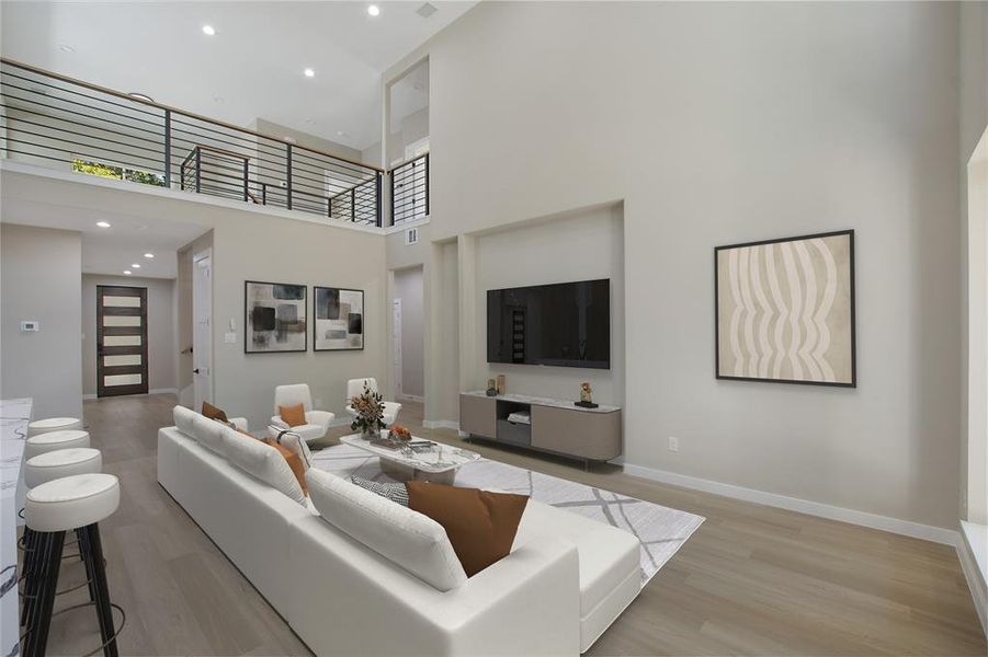 Living room featuring a towering ceiling and light wood-type flooring