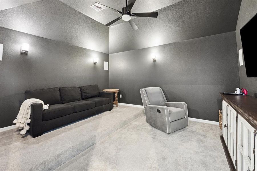 The modern and cozy media room is an ideal spot for entertainment and relaxation.