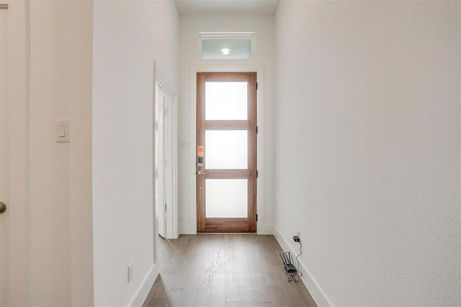 Doorway to outside featuring wood-type flooring