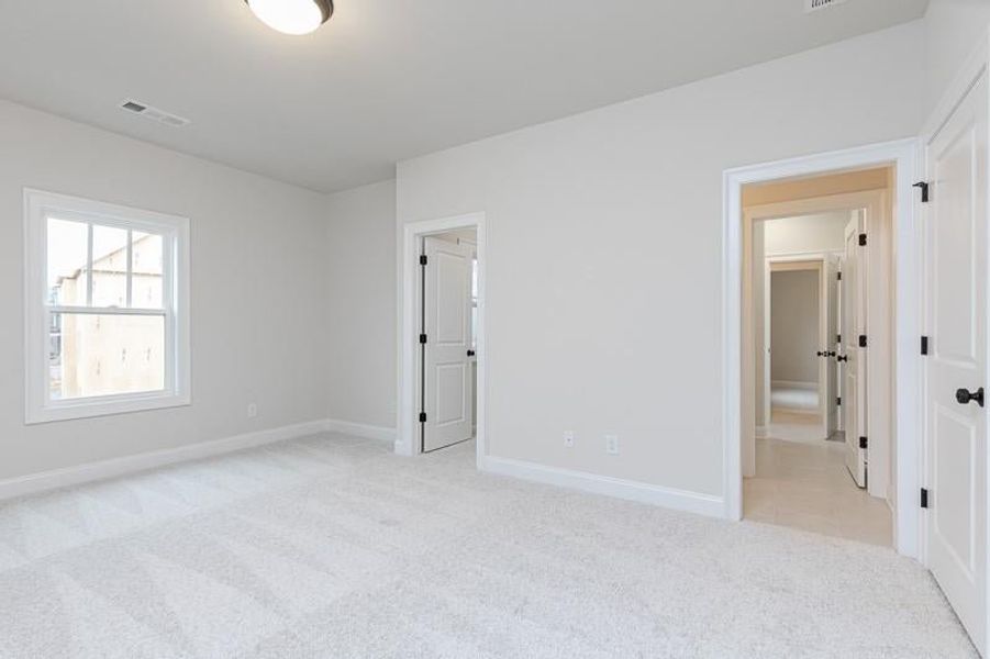 Additional bedroom with its walk-in closet with access to bathroom. Photo not actual home, but previously built Mansfield plan.