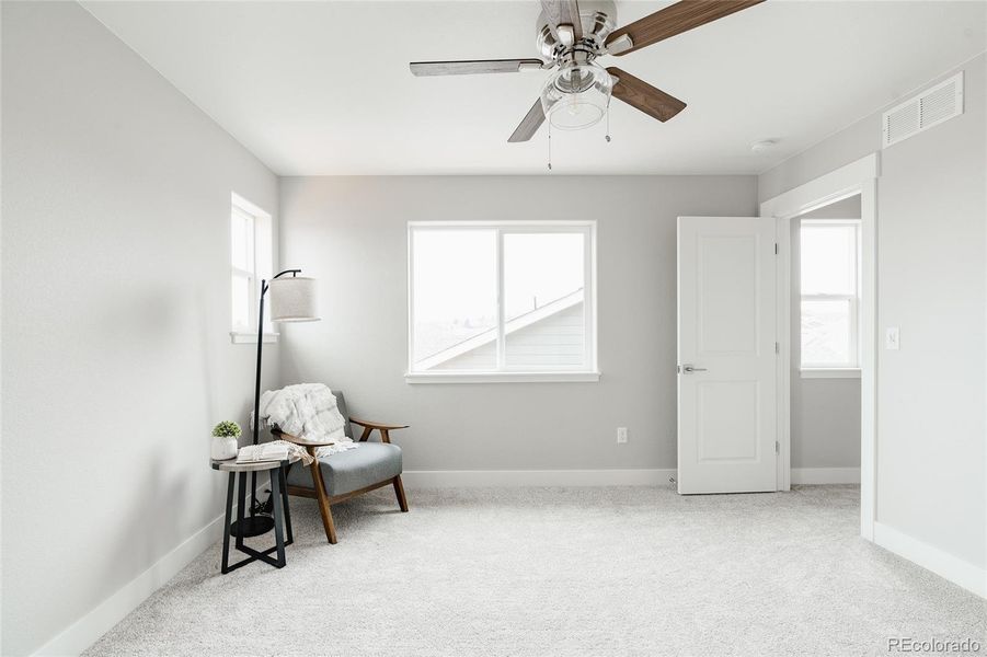 showing off three bedroom windows and a bright stairway landing through the door