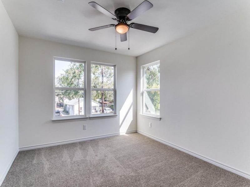 Spare room featuring ceiling fan and carpet