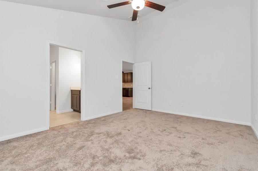 Step into the tranquil primary bedroom, conveniently connected to the luxurious en-suite bathroom. The soft, neutral tones create a serene environment, while the expansive layout offers ample space for your bedroom furniture and additional seating. **This image is from another Saratoga Home - Clover floorplan.**