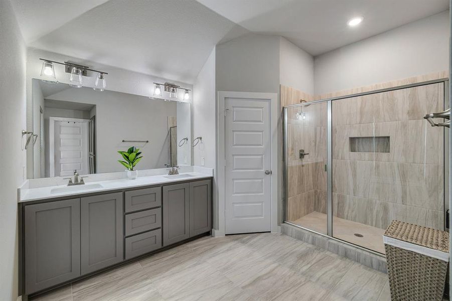 Bathroom featuring dual vanity, walk in shower, and tile patterned floors