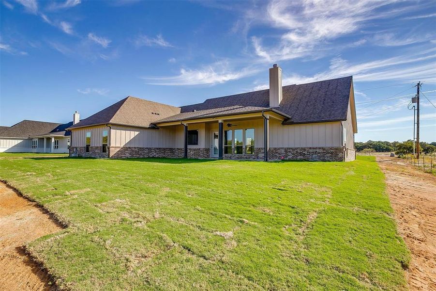 Rear view of property featuring a yard