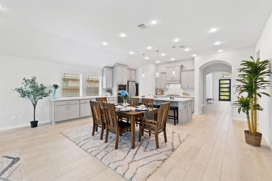 Adjacent to the kitchen, the dining area offers a comfortable space for meals and socializing, benefiting from the open floor plan that keeps the conversation flowing throughout the main living spaces.