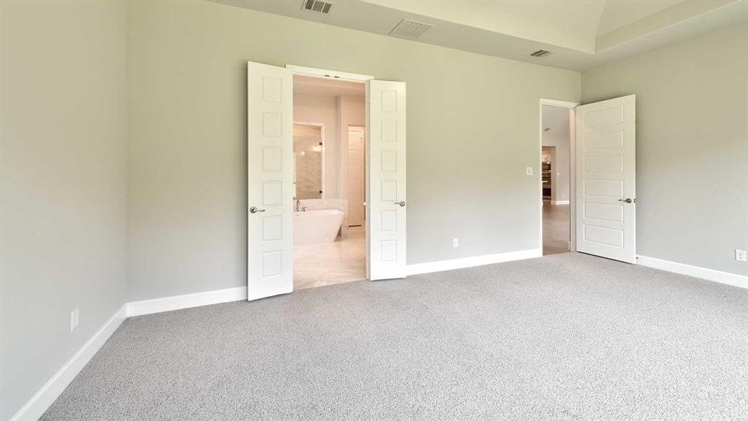 Unfurnished bedroom featuring carpet floors and ensuite bath