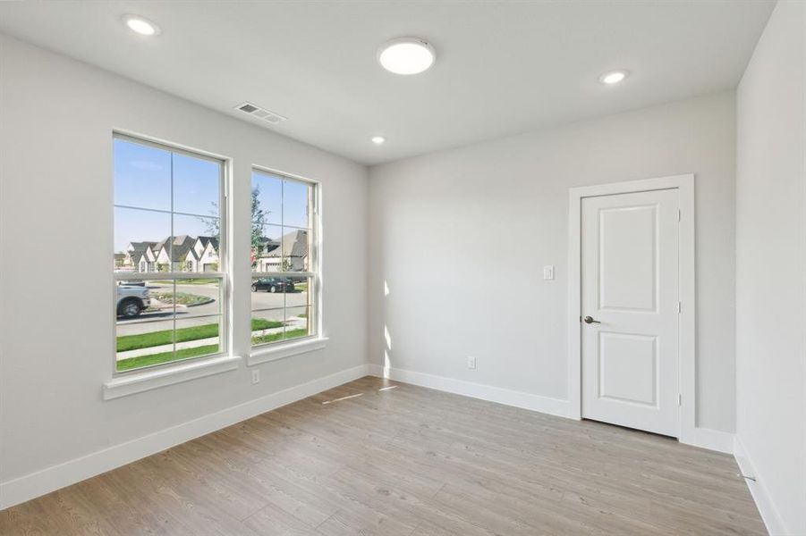 Unfurnished room with light wood-type flooring