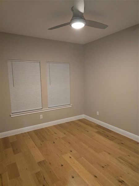 Spare room with light wood-type flooring and ceiling fan