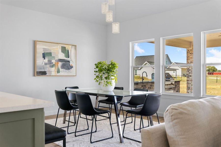 Dining space with light hardwood / wood-style flooring and plenty of natural light