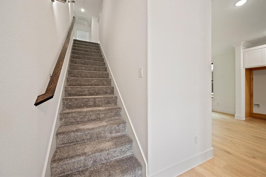 Staircase featuring light hardwood / wood-style floors