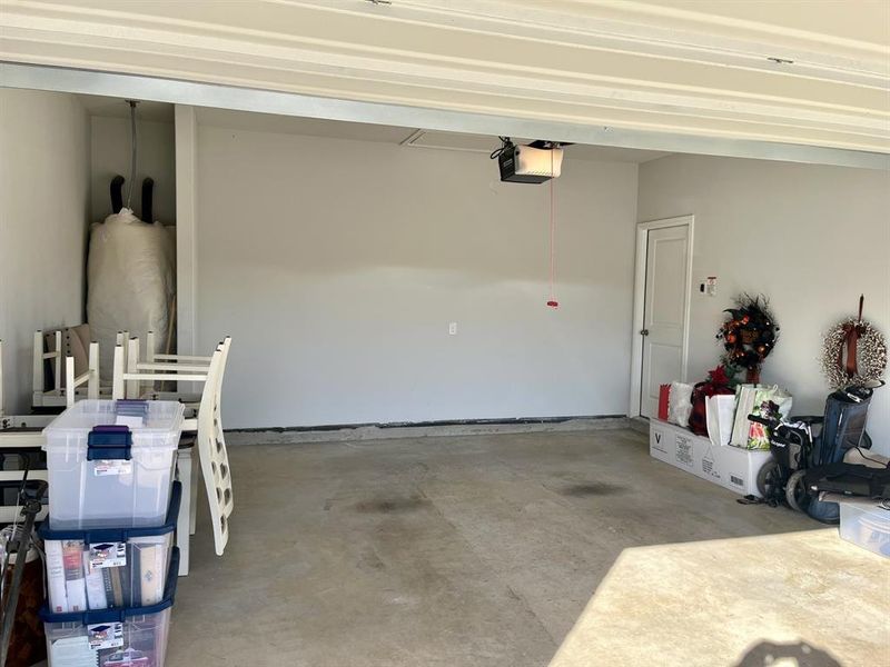 Garage featuring a garage door opener