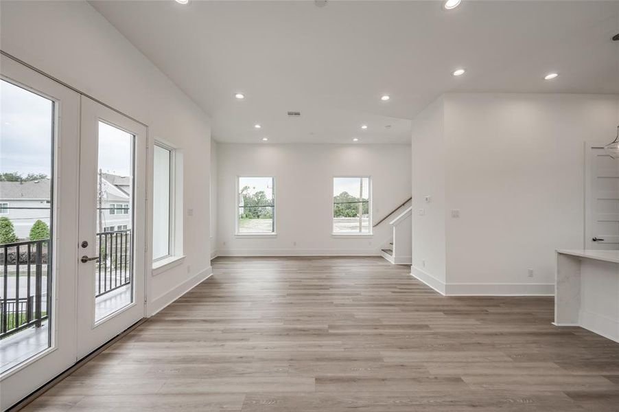 The expansive living and dining area has high ceilings and plenty of natural lighting.