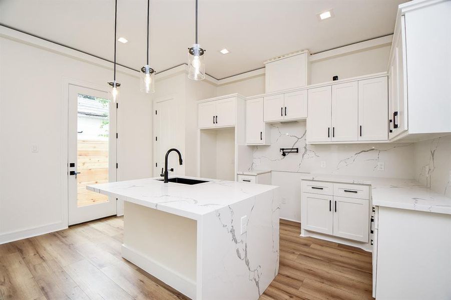 Custom Cabinets are just the start of features usually not found in a home at this price point. Here we see the white cabinet, luxury vinyl and grey streak quartz finishes.